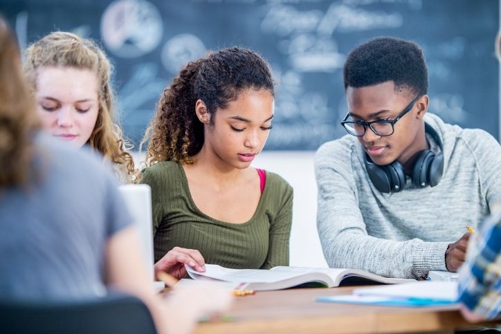 estudantes concentrados estudando juntos em sala de aula.